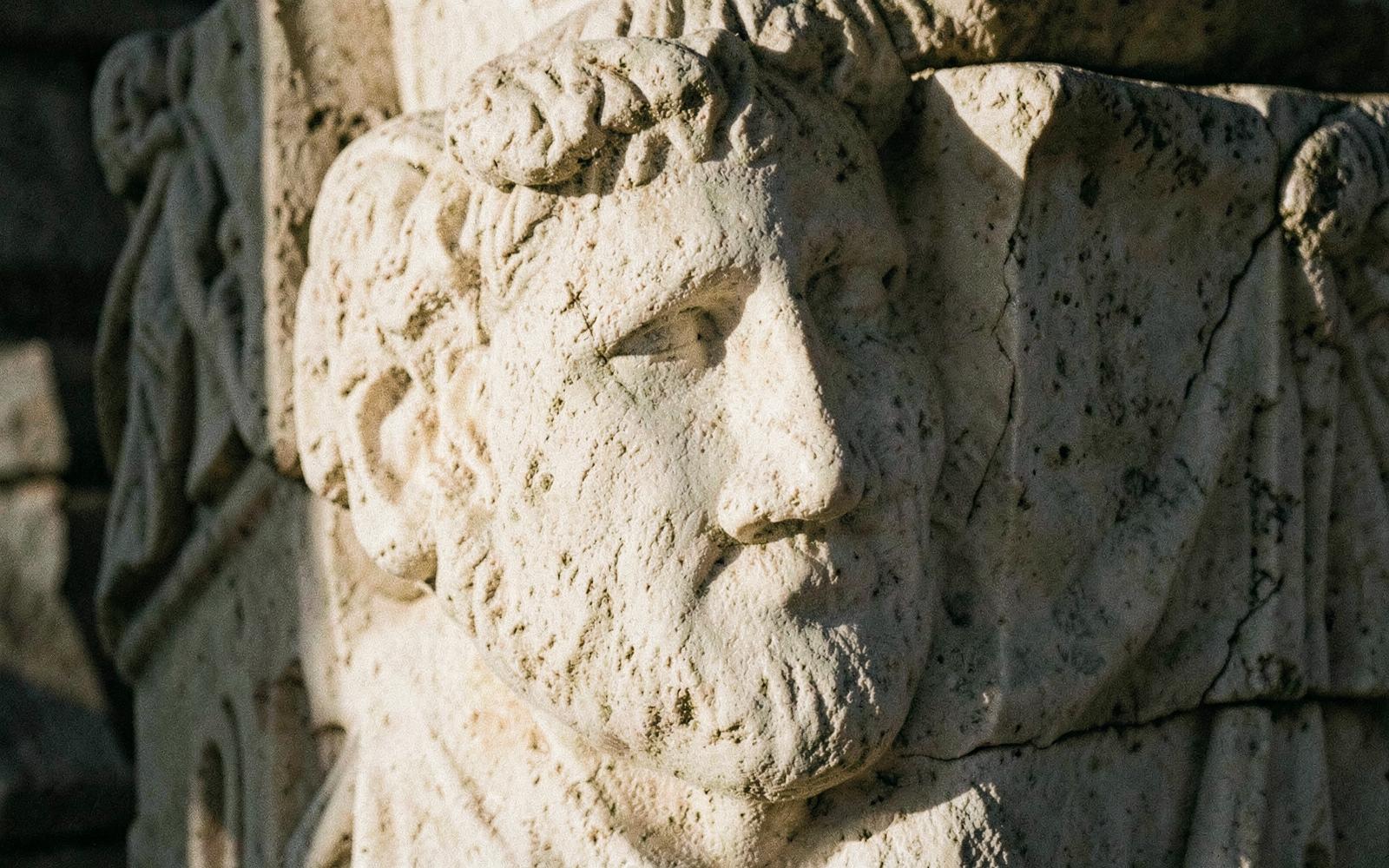 Ancient carved face in weathered marble